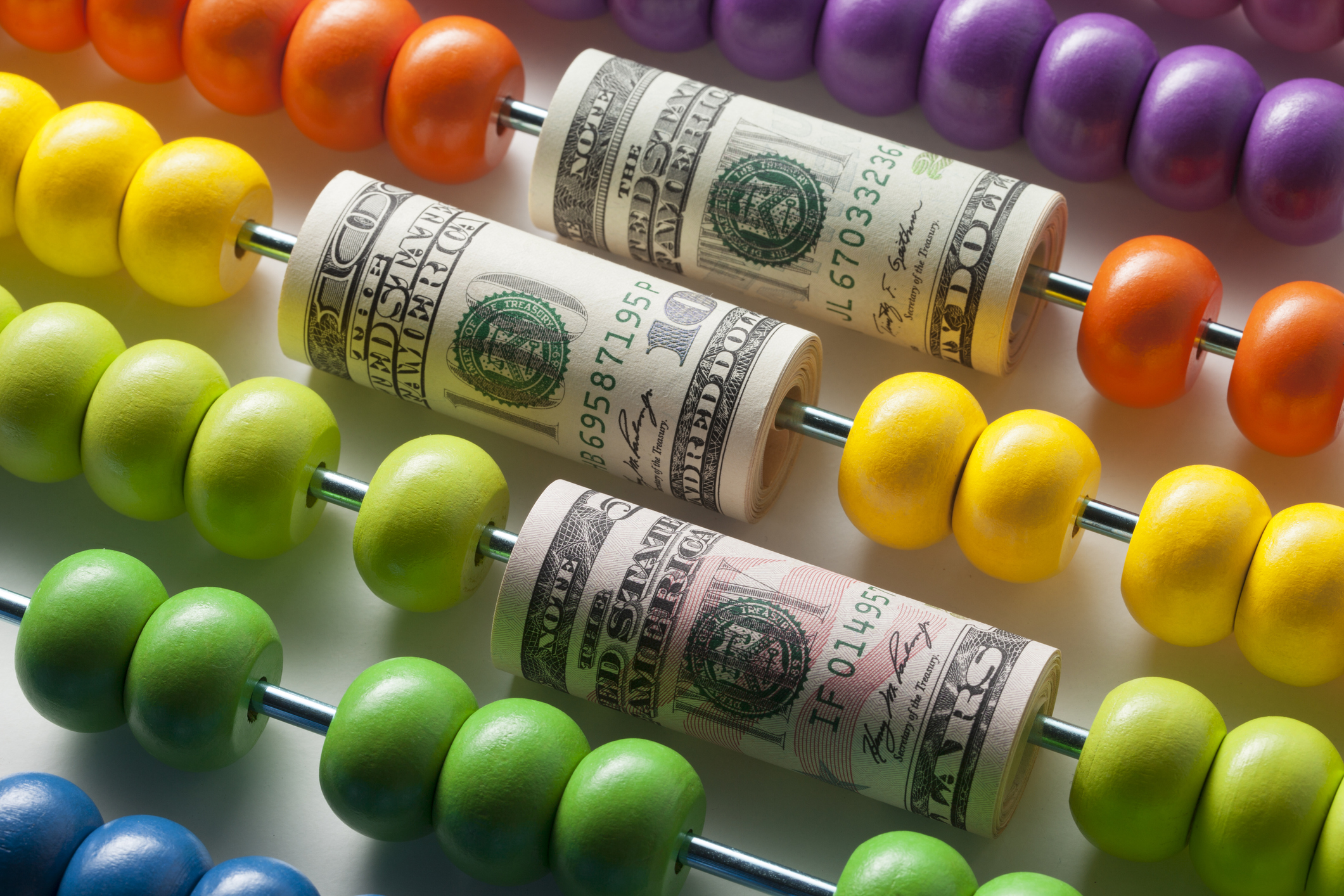 Abacus with rolls of dollar banknotes